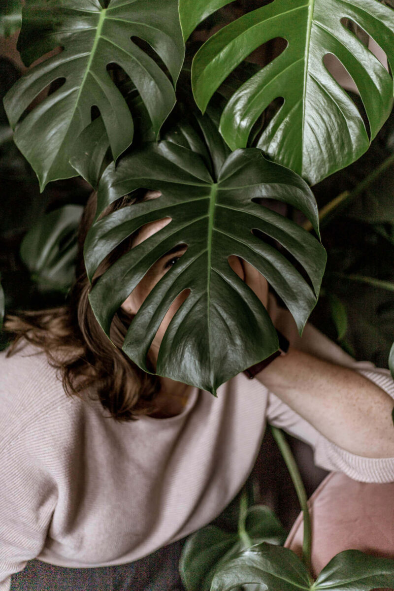 Aime hiding behind a plant. She's a proper businesswoman we promise.