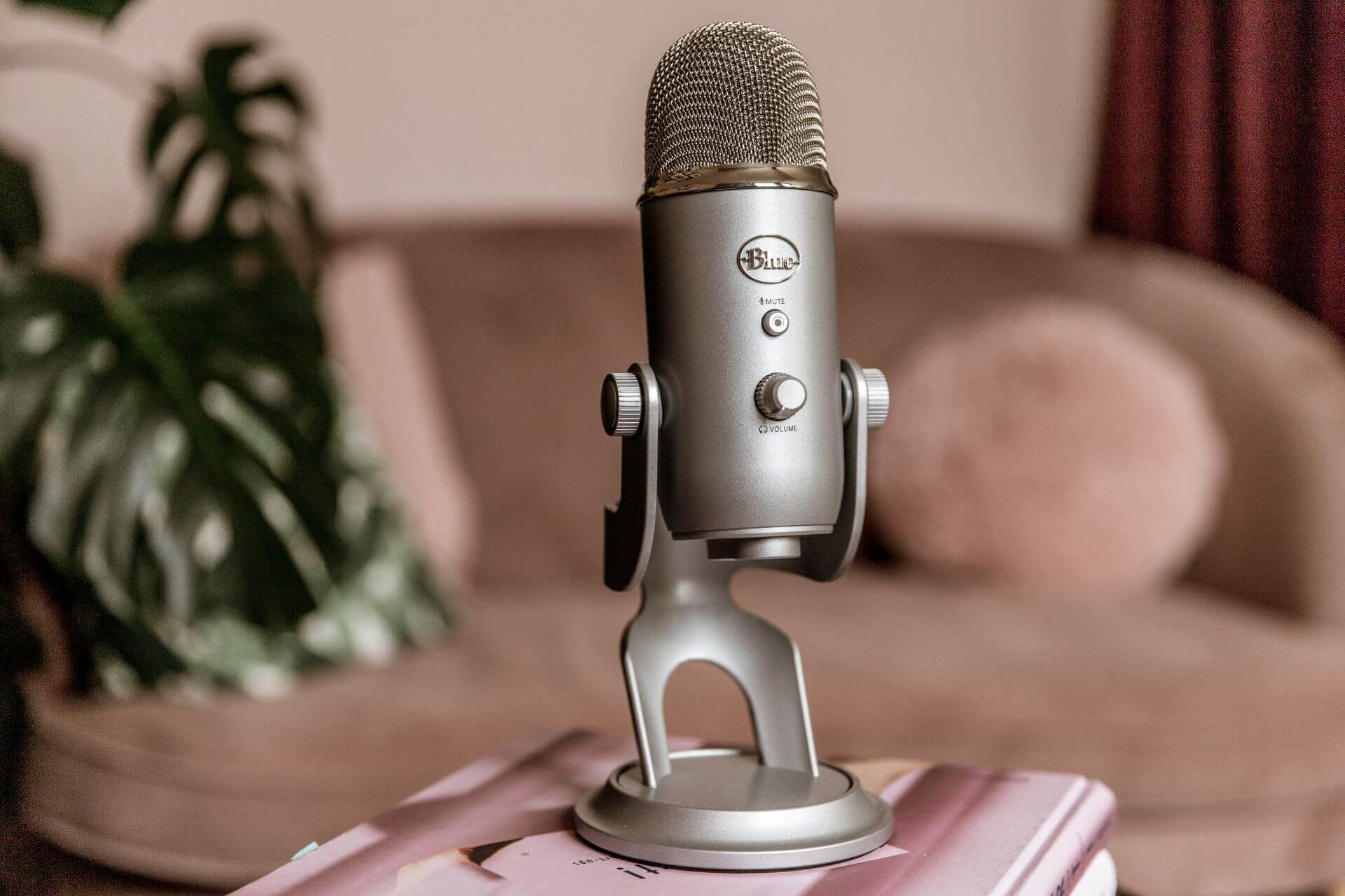 Podcast microphone on a pink magazine inside Studio Cotton