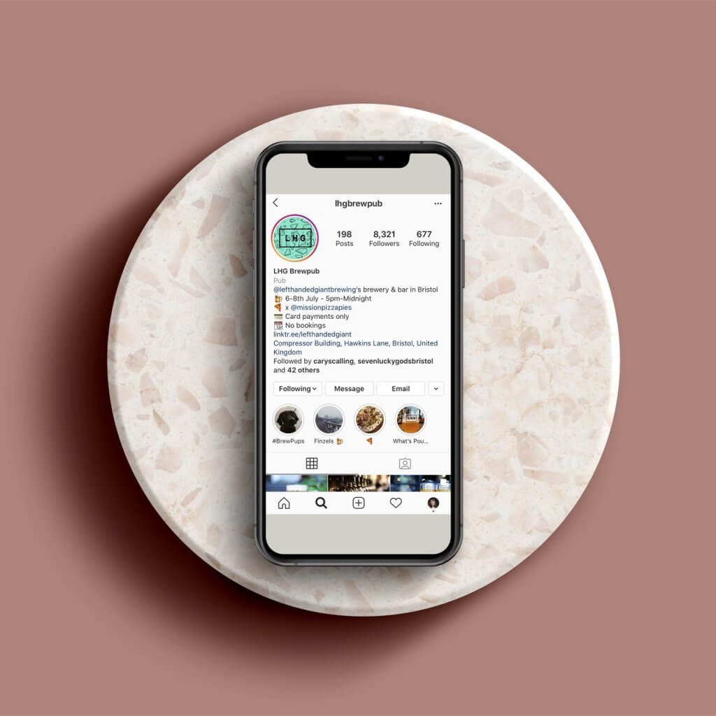 Instagram bio hone screen on phone resting on marble circle plate