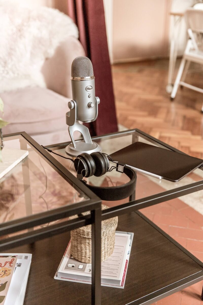 Podcasting microphone, headphones and iPad on a glass coffee table