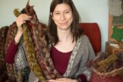 Marina Skua holding up natural hand-dyed yarn for her podcast on youtube